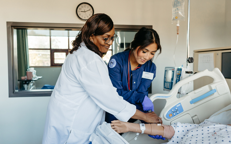 Nursing professor with student.