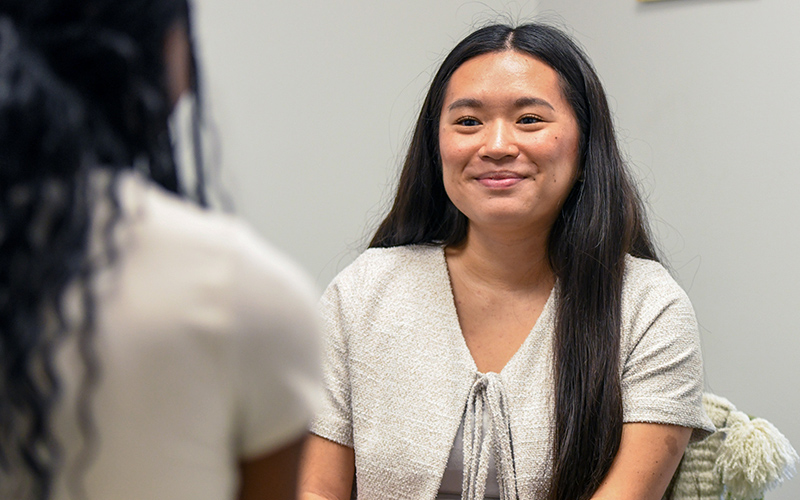 Staff member talking to student.