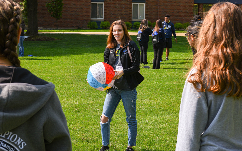 Student with a beach ball.